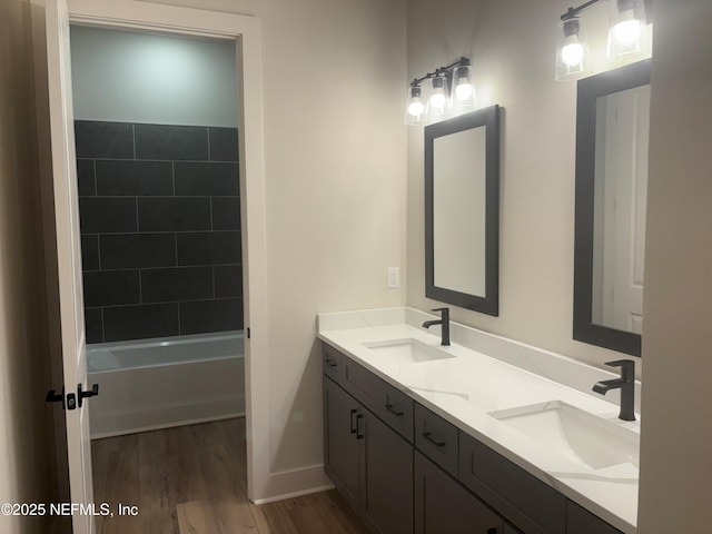 36199 Pitch Ln, Hilliard, FL 32046 - bathroom with double vanity, wood finished floors, baseboards, and bathtub / shower combination