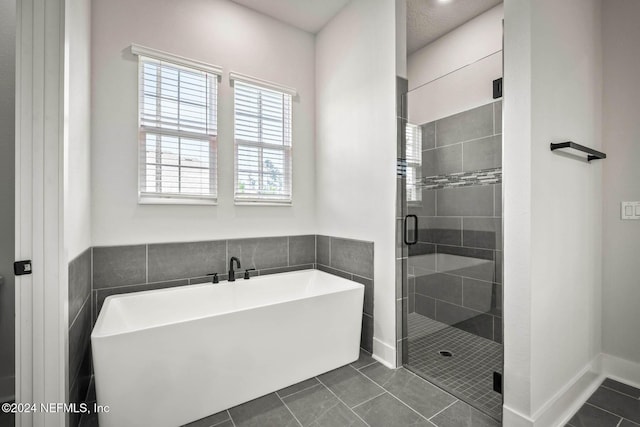 bathroom featuring tile patterned floors and plus walk in shower