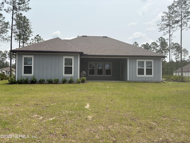 36231 Pitch Ln, Hilliard, FL 32046 - back of house featuring a lawn, roof with shingles, and board and batten siding