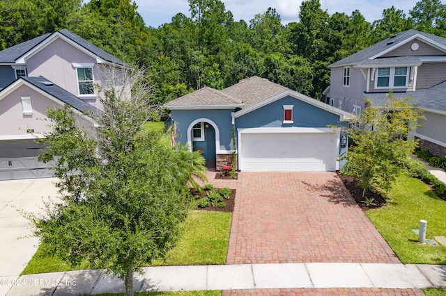 view of front of property featuring a garage and a front yard