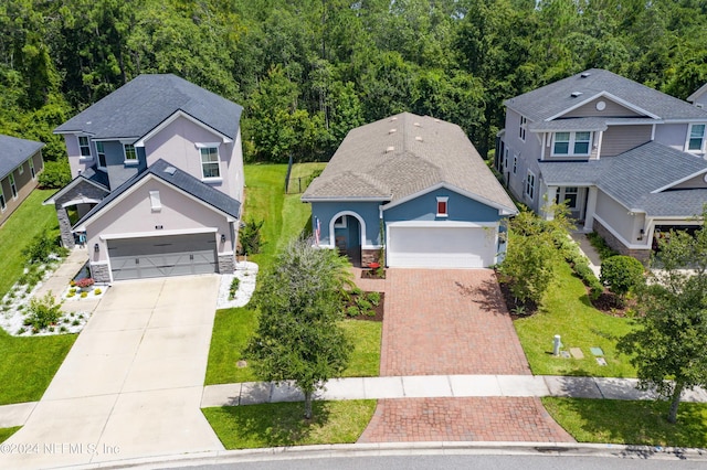 view of front of house featuring a garage and a front lawn