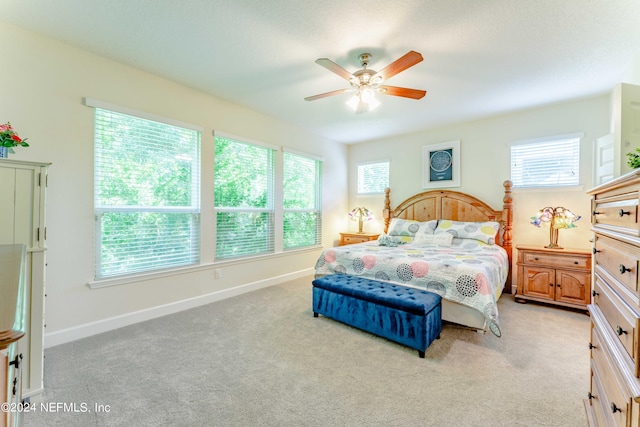 bedroom featuring light colored carpet and ceiling fan