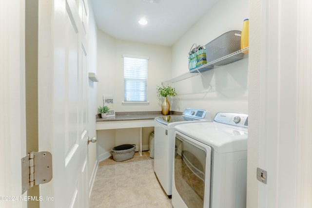 laundry room with light tile patterned flooring and washing machine and dryer