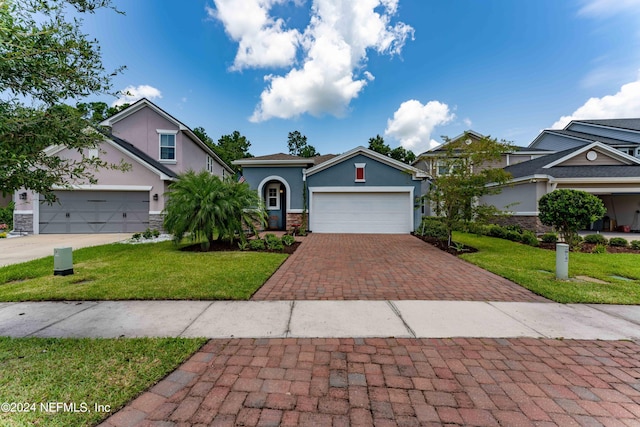 view of front of property featuring a front yard and a garage