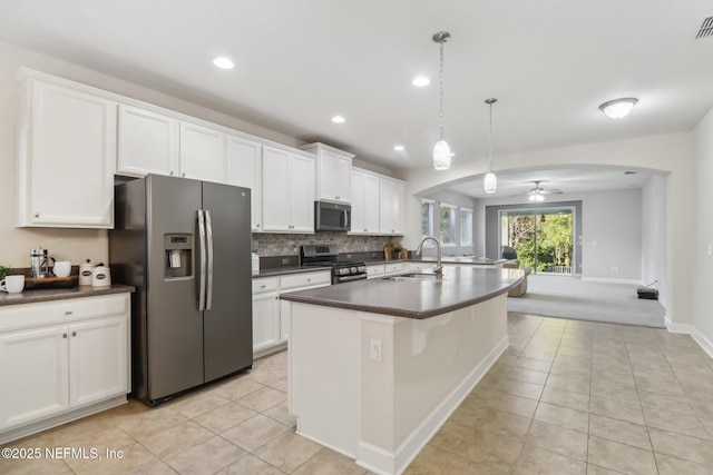 kitchen featuring white cabinets, sink, ceiling fan, appliances with stainless steel finishes, and decorative light fixtures