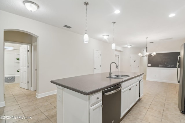 kitchen with sink, stainless steel appliances, white cabinets, a center island with sink, and light tile patterned flooring