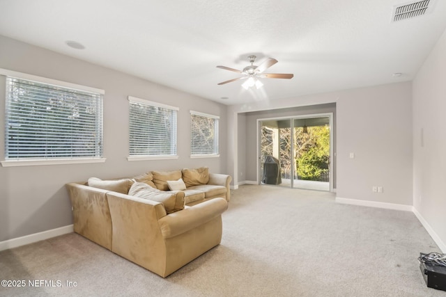 living room with light carpet and ceiling fan