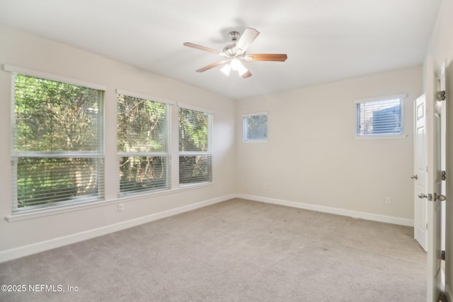 carpeted spare room featuring ceiling fan