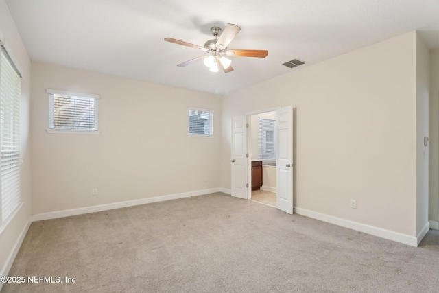 unfurnished bedroom with ceiling fan and light colored carpet