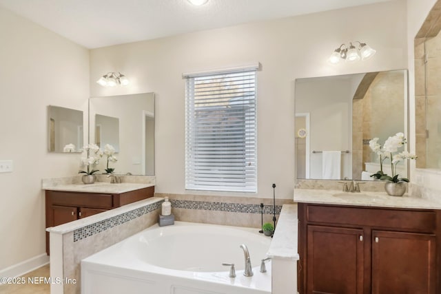 bathroom with vanity and separate shower and tub