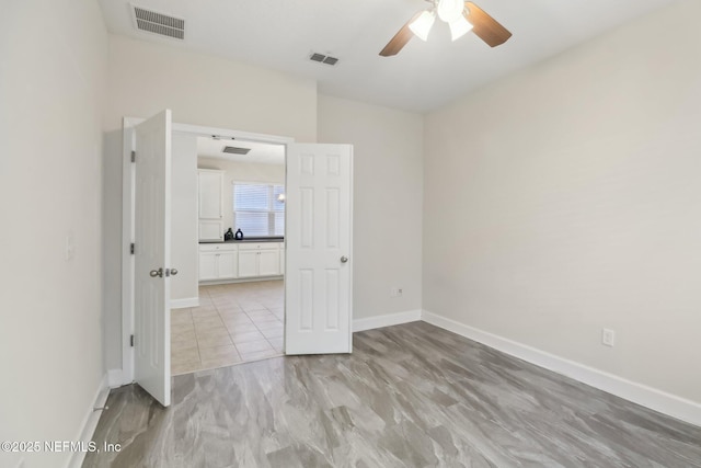 unfurnished room featuring ceiling fan and light wood-type flooring