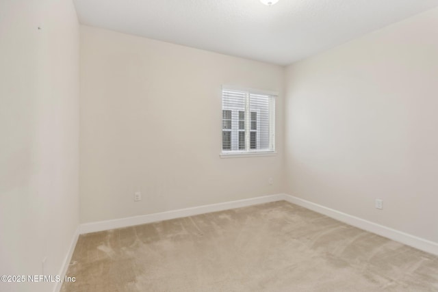 spare room with light colored carpet