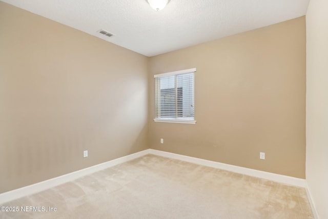 unfurnished room featuring carpet