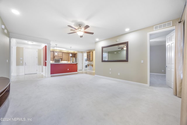 unfurnished living room with ceiling fan and light colored carpet