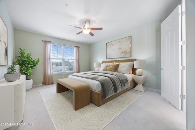 bedroom featuring ceiling fan and light colored carpet