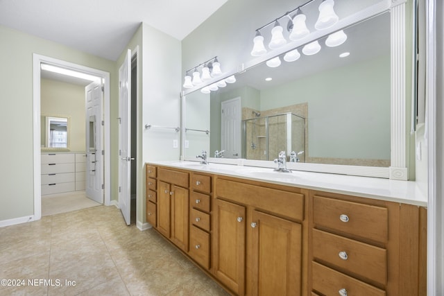 bathroom featuring vanity, tile patterned floors, and an enclosed shower