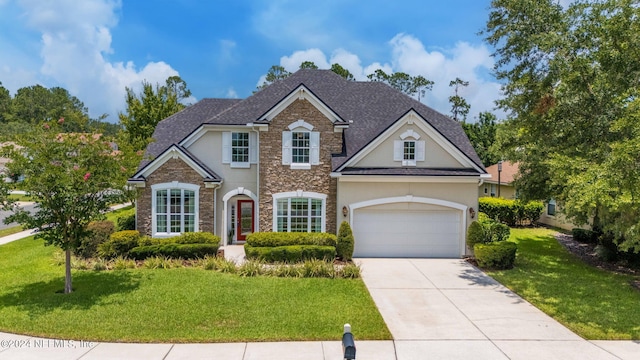 view of front facade with a garage and a front yard