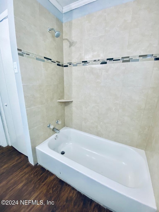 bathroom featuring hardwood / wood-style floors and tiled shower / bath