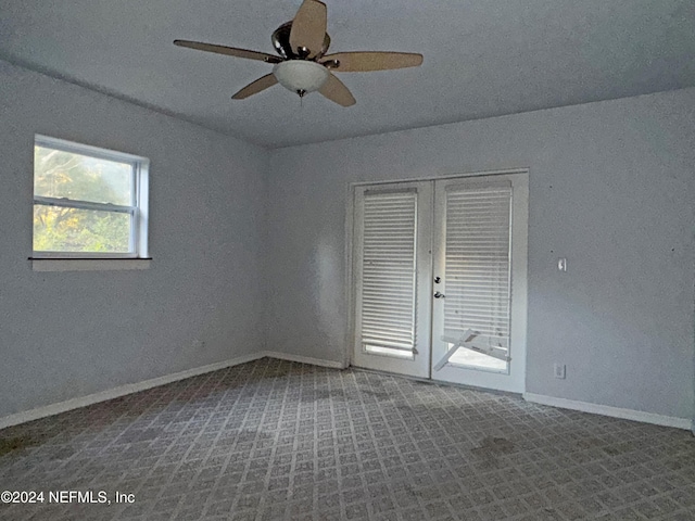 empty room with carpet flooring and ceiling fan