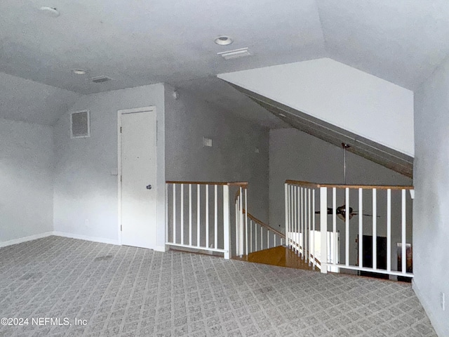 bonus room featuring carpet floors and vaulted ceiling