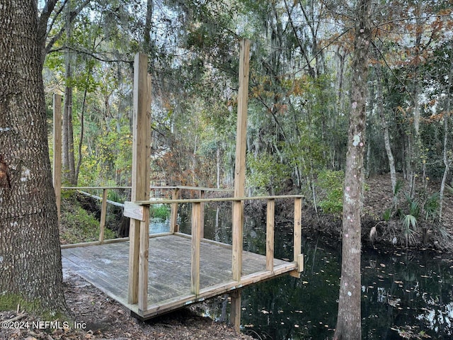 wooden terrace featuring a water view