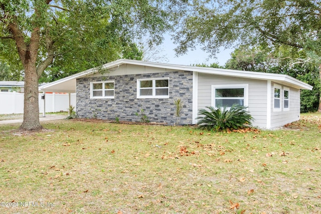 exterior space featuring a carport and a front yard