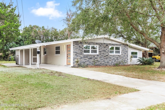 ranch-style home featuring a front yard and a carport