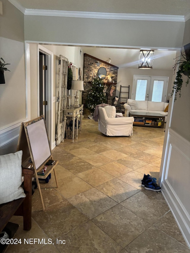 living room with french doors, lofted ceiling, ornamental molding, and a notable chandelier