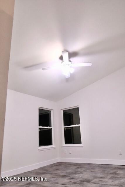 spare room with ceiling fan and built in shelves