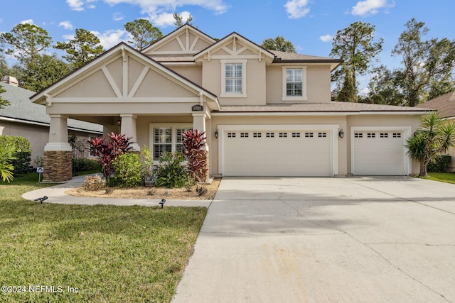 view of front facade with a front yard and a garage