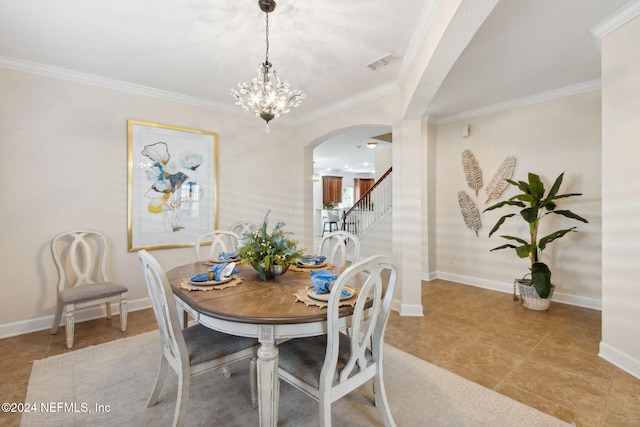 tiled dining room with ornamental molding and an inviting chandelier