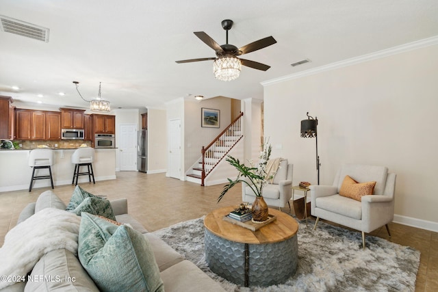 tiled living room featuring crown molding and ceiling fan with notable chandelier