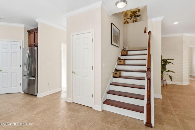 staircase with tile patterned flooring and crown molding