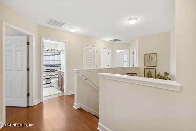 hallway with hardwood / wood-style flooring