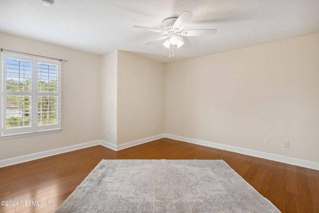 unfurnished room featuring ceiling fan and dark hardwood / wood-style floors