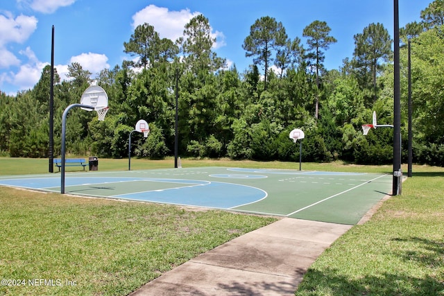 view of basketball court with a lawn