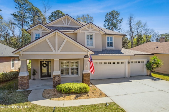 craftsman-style house featuring concrete driveway, roof with shingles, and stucco siding