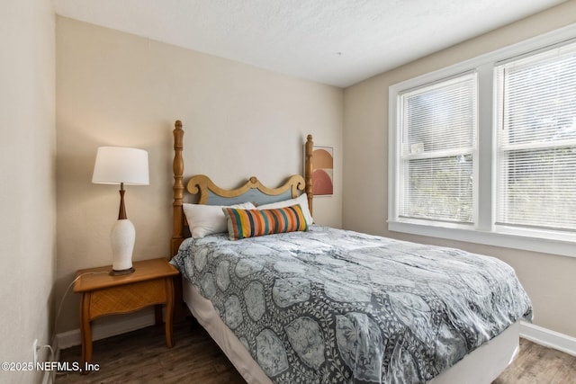 bedroom with multiple windows and wood-type flooring