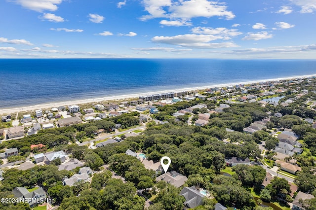 drone / aerial view featuring a water view and a view of the beach