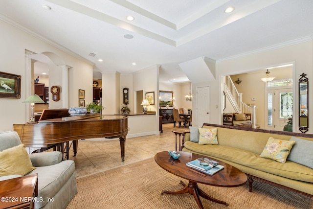 living room with light tile patterned floors, crown molding, and decorative columns