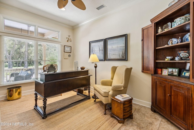 interior space with ceiling fan and ornamental molding