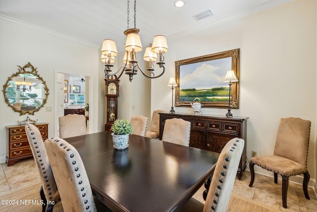 dining area with crown molding and a chandelier