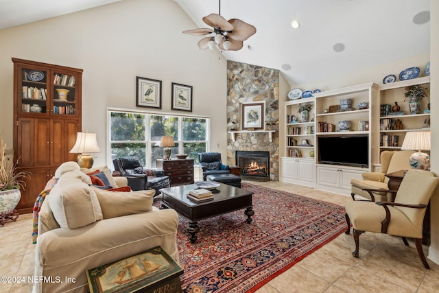 tiled living room with a stone fireplace, ceiling fan, built in features, and high vaulted ceiling