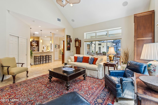 living room featuring ceiling fan, light tile patterned floors, and high vaulted ceiling