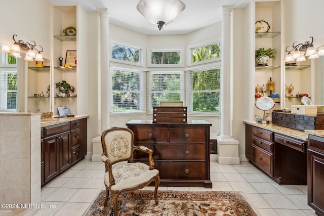 living area with built in features, ornate columns, and light tile patterned floors