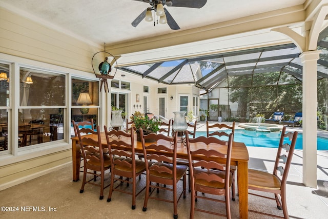 sunroom / solarium with ceiling fan and lofted ceiling