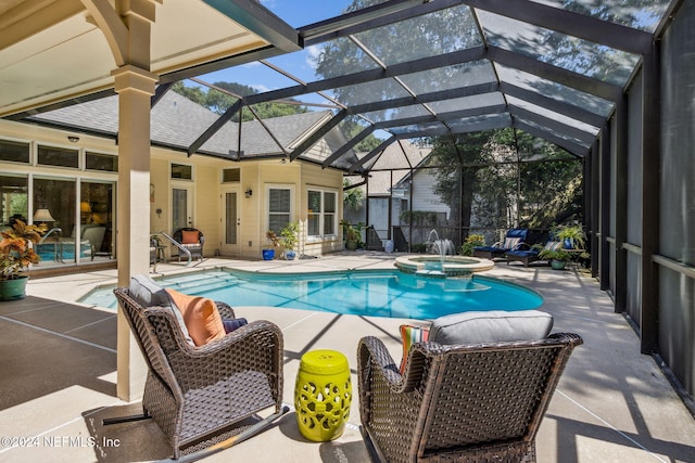 view of swimming pool with a patio area, a lanai, and an in ground hot tub