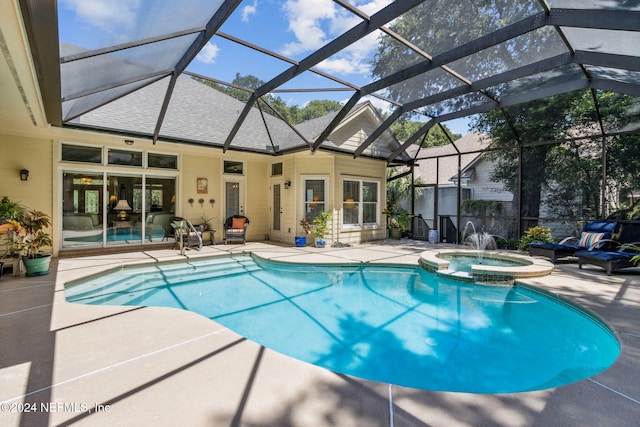 view of swimming pool featuring an in ground hot tub, pool water feature, a patio, and glass enclosure