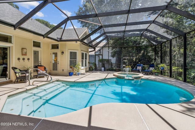 view of swimming pool featuring an in ground hot tub, a patio, and a lanai