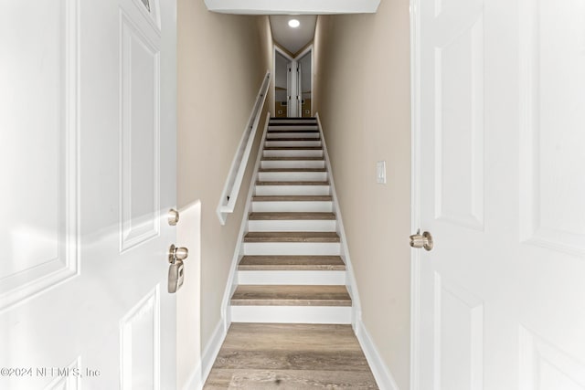 stairs with hardwood / wood-style floors